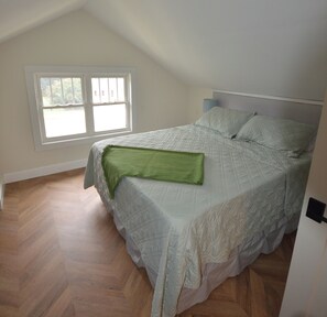 A bedroom with a bed, a window, and a door. - Modern Huntersville Retreat : Minutes to Lake Norman & Birkdale Village! (Huntersville)