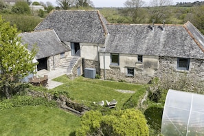 A stone house with a sloped roof, a small garden, and a clear sky. - Mowhay Barn - sleeps 6 guests  in 3 bedrooms (Helford)