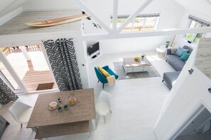 A spacious living area with a dining table, seating, and a television. - Skylark Beach House - sleeps 6 guests  in 3 bedrooms (Hayle)