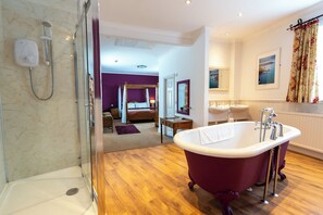A modern bathroom with a freestanding bathtub, a shower area, and a large mirror.