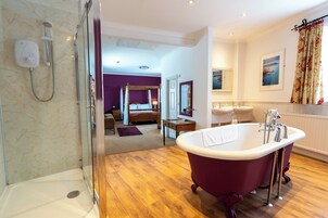A modern bathroom with a freestanding bathtub, a shower area, and a large mirror.