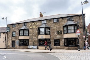 A traditional stone building with a sign reading 'YACKS HOTEL'.
