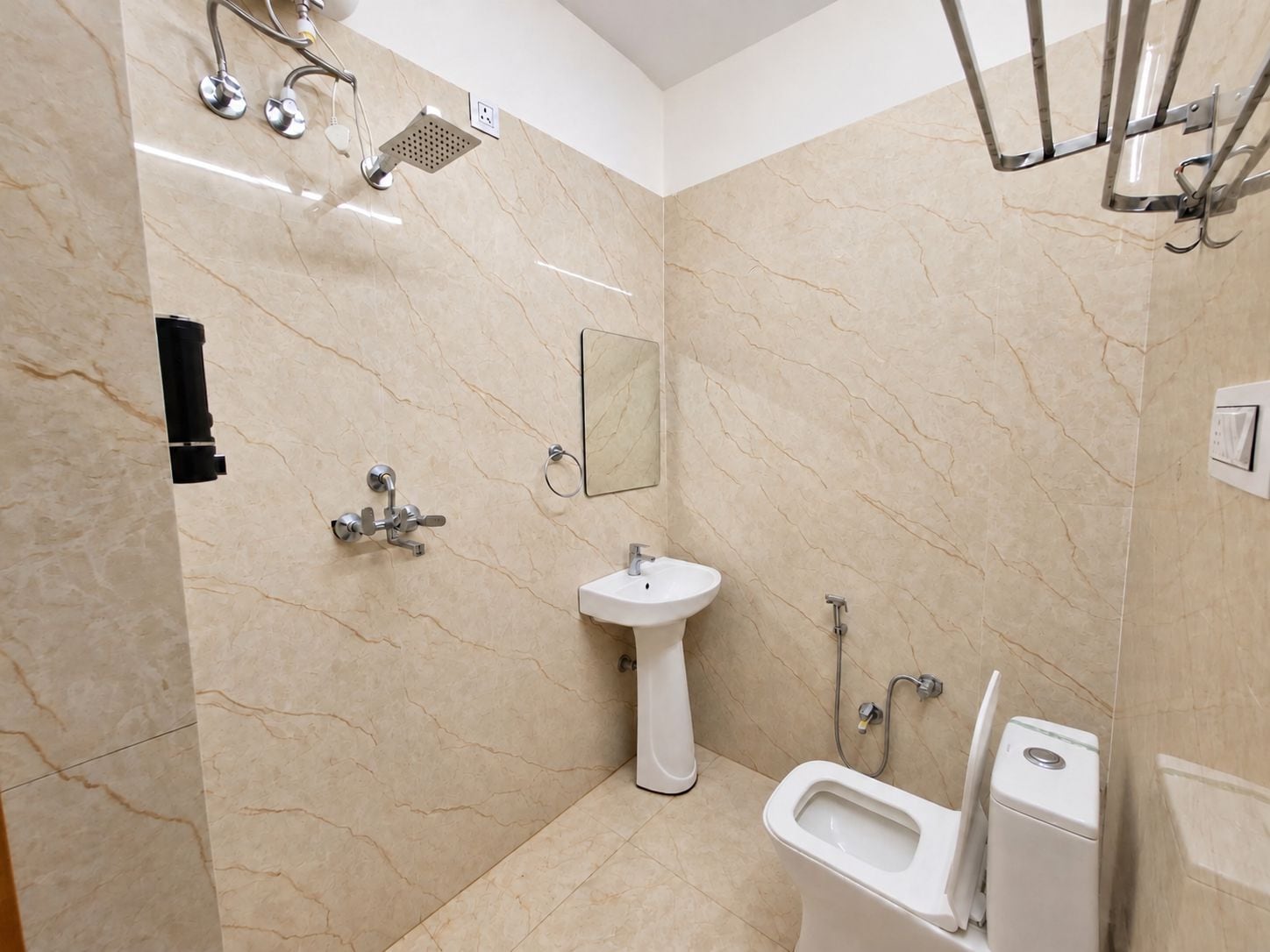 A bathroom with a shower, sink, toilet, and a mirror.