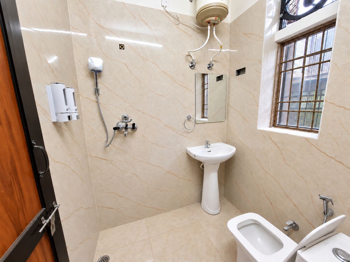 A bathroom with a sink, bidet, and shower.