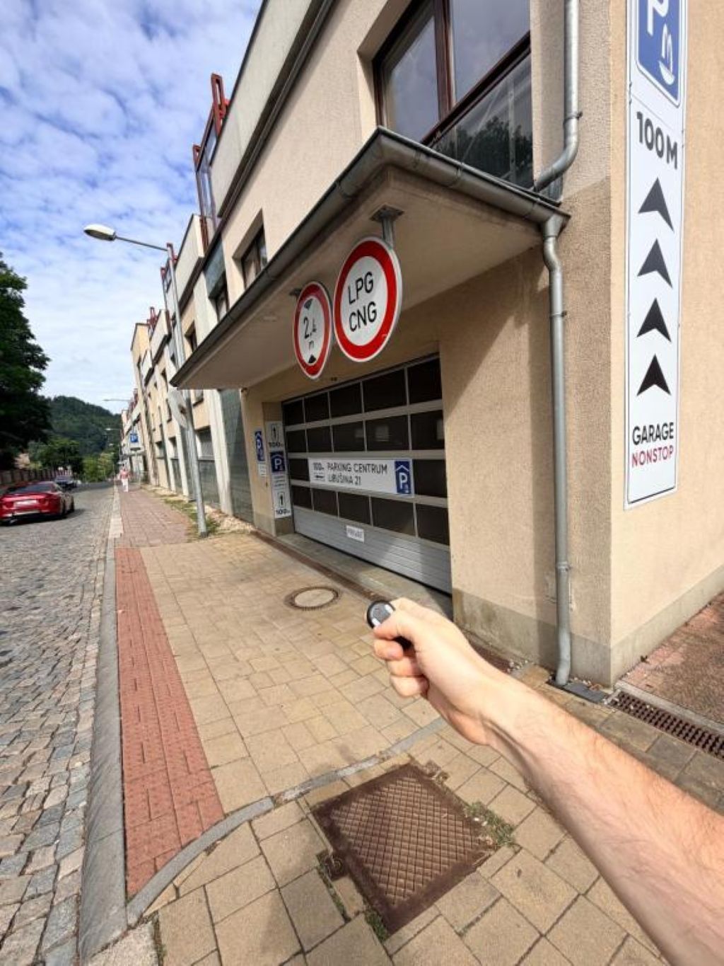 A building with a garage sign, a no parking sign, and a no stopping sign.