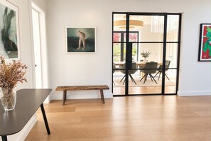 A modern interior with a dining area, a bench, and artwork on the walls. - Located in the heart of Adare village, 150yards from Ryder Cup Adare Manor (Adare)