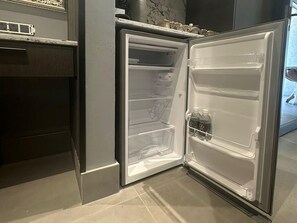 A modern kitchen with a built-in refrigerator, a countertop, and a tiled backsplash.