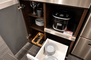 A compact kitchen with a built-in oven, a microwave, and a stainless steel refrigerator. - SLEEPLAB THE STAY Shibaura (Minato)