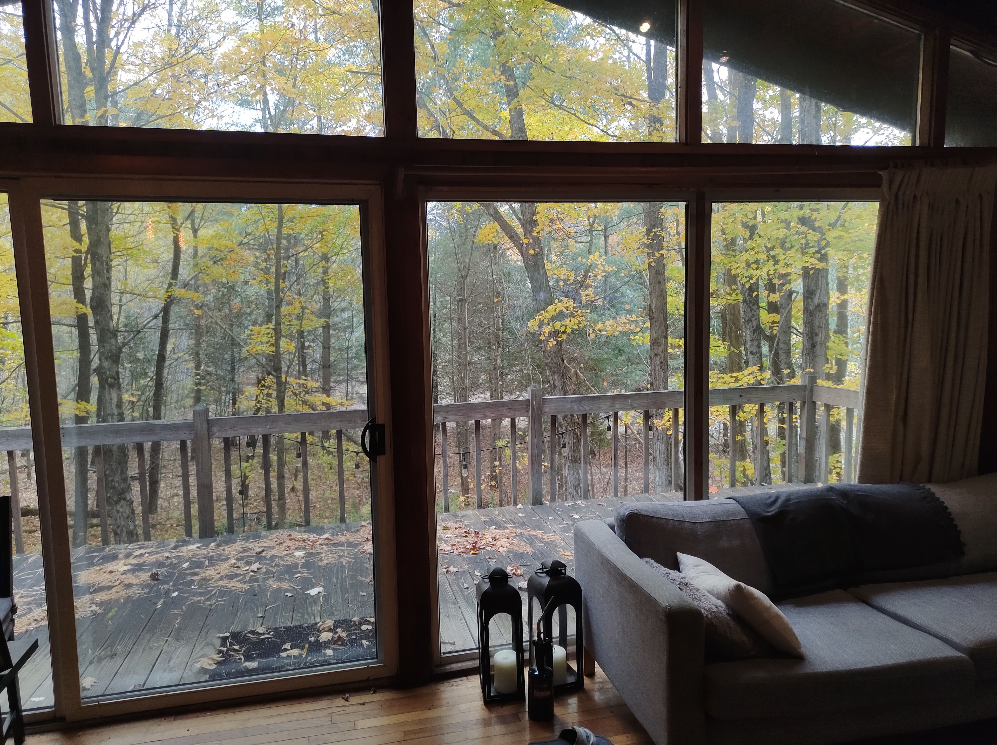A room with a large sliding glass door leading to an outdoor deck.