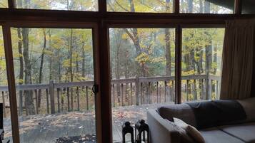 A room with a large sliding glass door leading to an outdoor deck.
