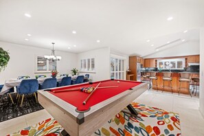 A modern living space with a pool table, dining area, and kitchen. - 6BD/3.5BA Wine Country Home w/ Solar Heated Pool + Billiards + BBQ (Santa Rosa)