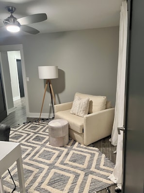 A room with a ceiling fan, a lamp, a sofa, a rug, and a door. - Apartment Oasis, 1 br plus office and spa bath in Chicago near public transport (Chicago)