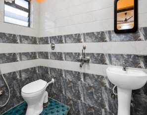 A bathroom with a toilet, bidet, and sink. - Deluxe Crescent Garden (Danapur)