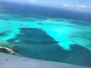 An aerial view of a coastal area with clear turquoise waters and sandy beaches. - Coming Soon, Spectacular Beachfront Villa, Bahama Bliss  (Wemyss)