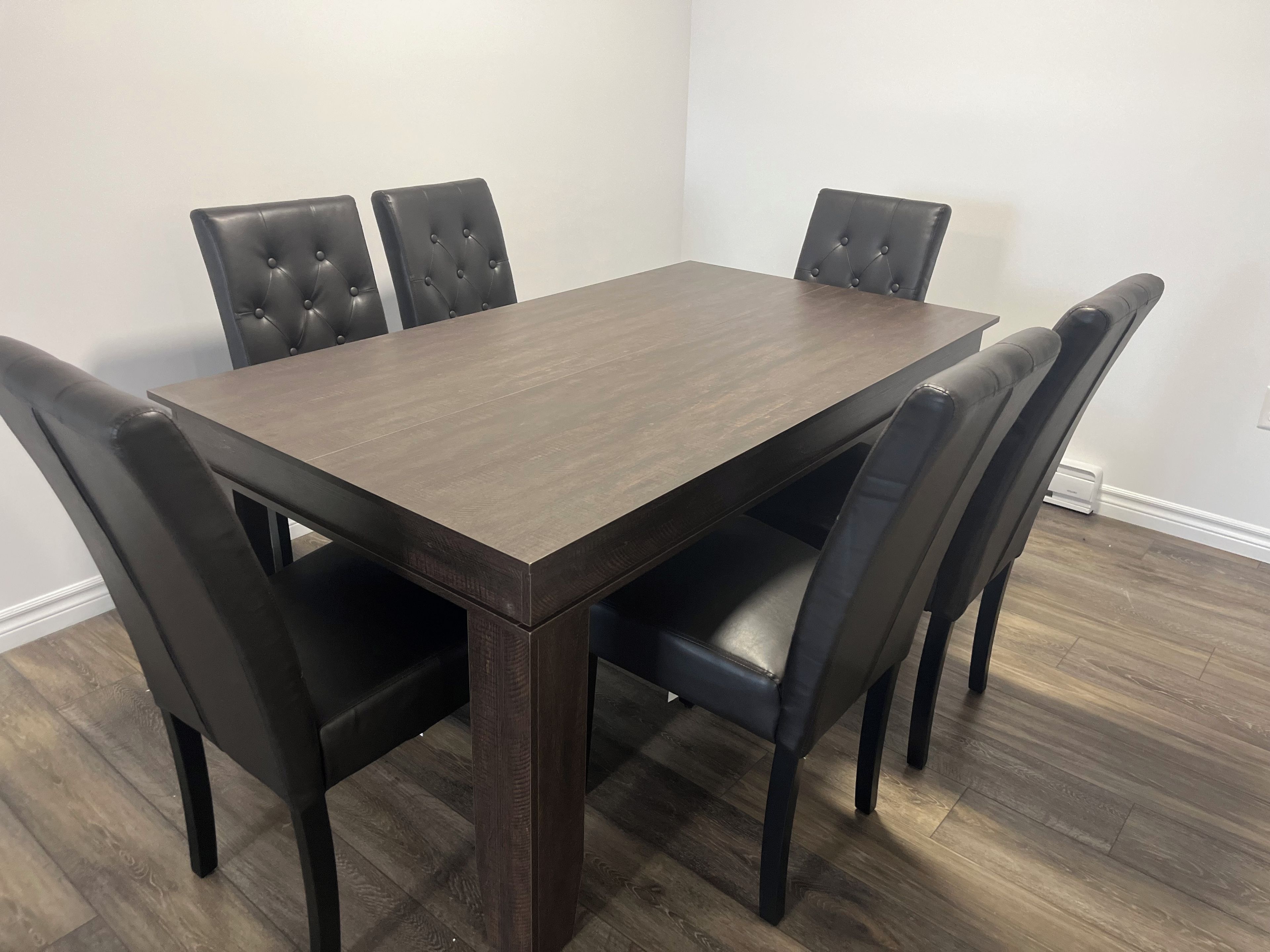 A rectangular dining table with six upholstered chairs.