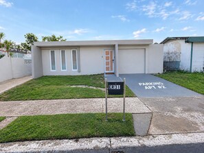 A modern building with a parking area marked 'PARKING APT #2' and a mailbox labeled 'ER 31'. - 2-bedroom apartment, living room, bathroom, with its own parking space (Toa baja)