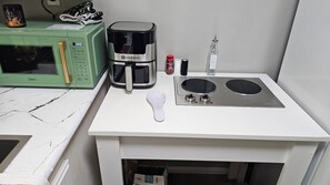 A kitchenette with a microwave, coffee maker, and a stove. - New 1bedroom ,  Close to Beach, pet friendly (OXNARD)
