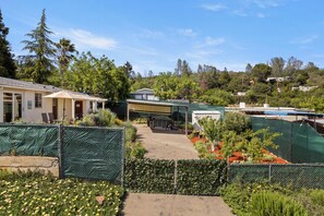 A residential area with houses, a fenced garden, and a clear sky. - Peaceful home fully fenced/gated circle driveway and ready for your stay! (Kelseyville)