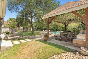 A backyard with a patio, outdoor seating, a pool, and a pergola. - Austin Chateau Estate: Pool, Hot Tub, Saunas, Cold Plunge, Gym & Theater (Austin)