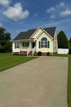 A two-story house with a front porch, a driveway, and a well-maintained lawn. - >The Pacific Home< (Winterville)