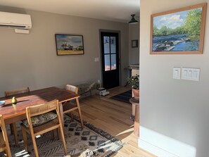 A dining area with a wooden table and chairs, a small rug, and a painting on the wall. - Flatirons View Home Near Sundance Festival -  Private Main Floor, Boulder (Boulder)