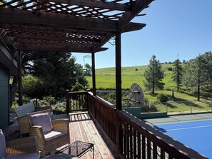 A wooden deck with outdoor furniture, a pergola, and a view of a green landscape. - Flatirons View Home Near Sundance Festival -  Private Main Floor, Boulder (Boulder)