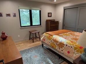 A bedroom with a bed, a wooden dresser, a window with blinds, a small stool, and a rug. - Flatirons View Home Near Sundance Festival -  Private Main Floor, Boulder (Boulder)