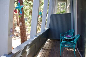 A wooden deck with two turquoise chairs and a small table, surrounded by white railings and a gray wall. - 2BD/2BA Condo Near Bike Path/Shuttle Stop/Village/Lodges (Mammoth Lakes)