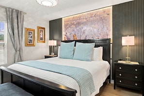 A modern bedroom with a large bed, two bedside tables, a headboard with a mural, and a window with curtains. - 6BR Near Disney, Pool, Games and Themed Rooms (Kissimmee)