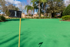 A golf course with a flag marking the first hole. - Chic 6br, Pool, Themed Rooms, Near Disney (Kissimmee)