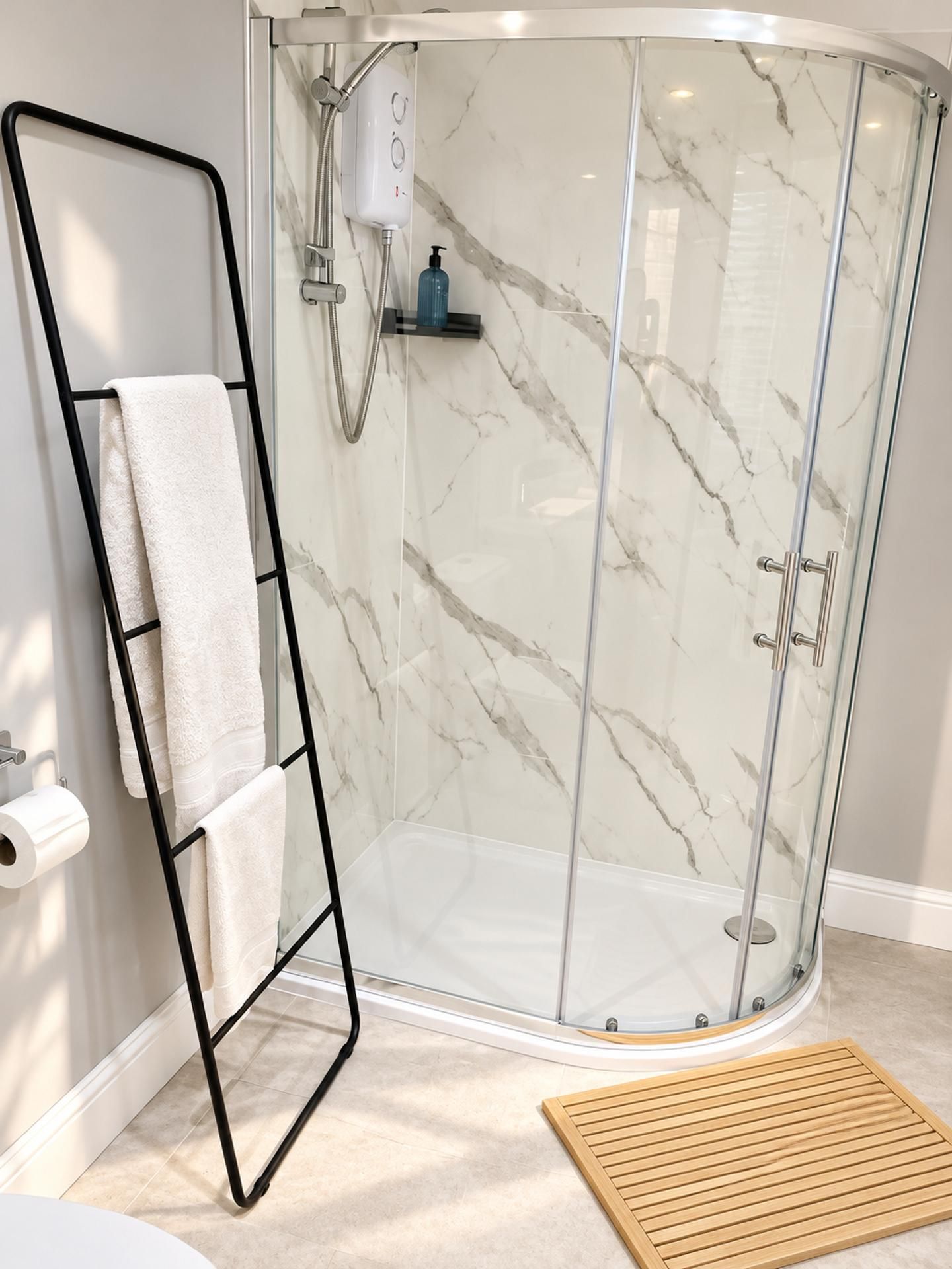 A glass-enclosed shower with a marble wall, a towel rack, and a wooden mat.
