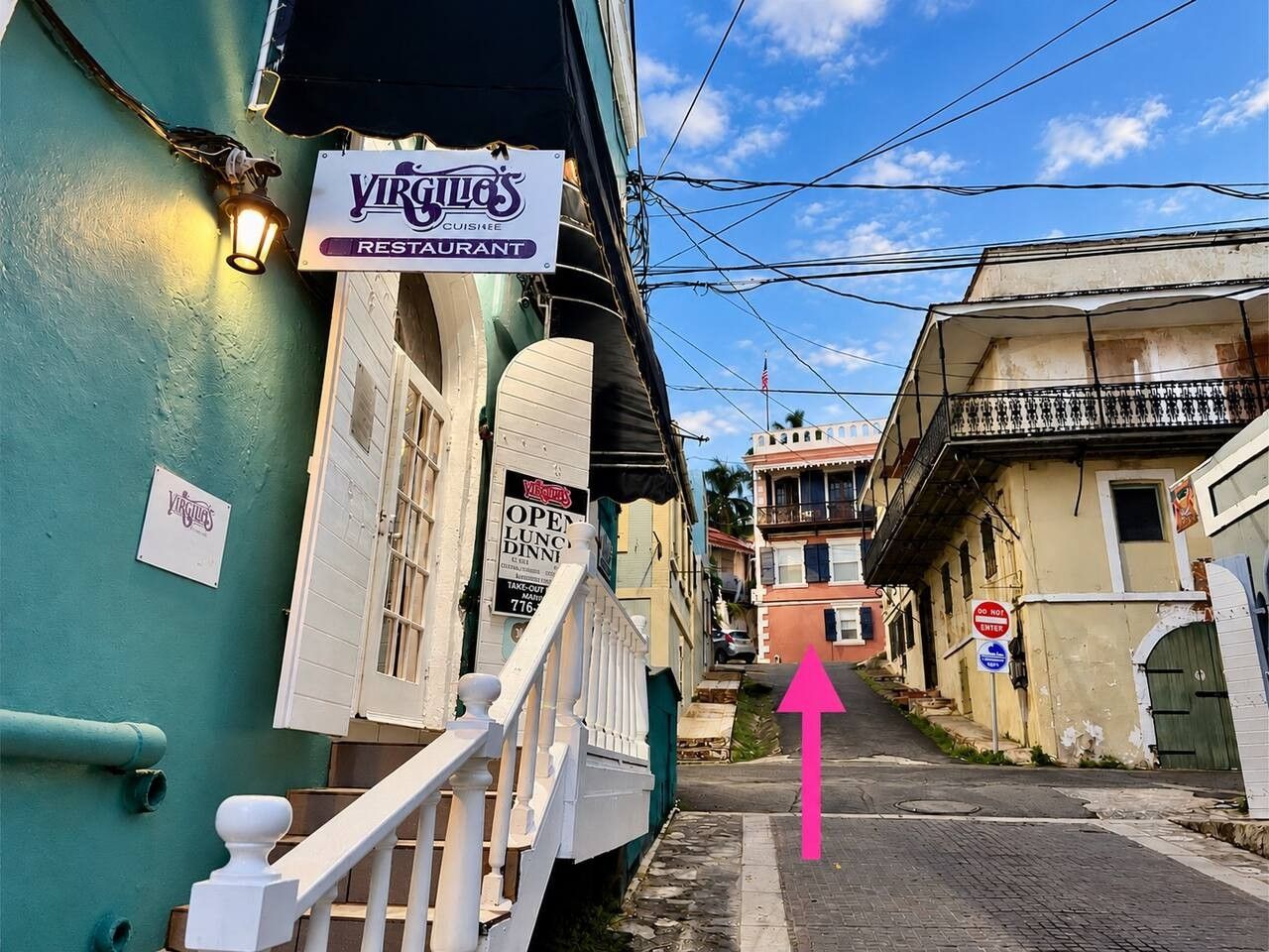 A street view with a restaurant sign, a staircase, and a 'Do Not Enter' sign.