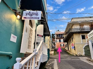 A street view with a restaurant sign, a staircase, and a 'Do Not Enter' sign. - King’s Lighthouse Blue Door | Ground Floor Retreat (Charlotte Amalie)