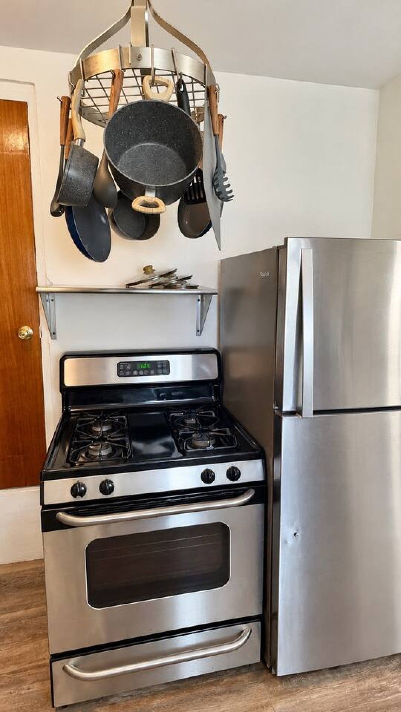 A kitchen with a stainless steel stove, oven, and refrigerator.