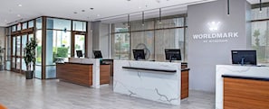 A modern reception area with marble counters, glass doors, and a logo for 'WORLDMARK BY WYNDHAM'. - Resort 1 bedroom in Anaheim for National Association of Music Merchants - NAMN (Anaheim)
