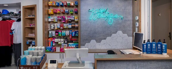 A boutique store interior with shelves of toiletries, a neon sign, and a computer monitor. - Resort 1 bedroom in Anaheim for National Association of Music Merchants - NAMN (Anaheim)