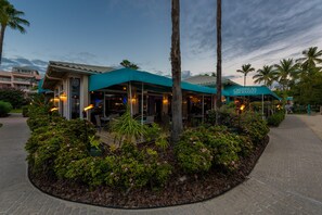 A restaurant with outdoor seating, surrounded by landscaped gardens and palm trees. - Luxury Island Escape 3BR, Panoramic Views, AC, Pool, Free Concierge, & Generator (St Thomas)