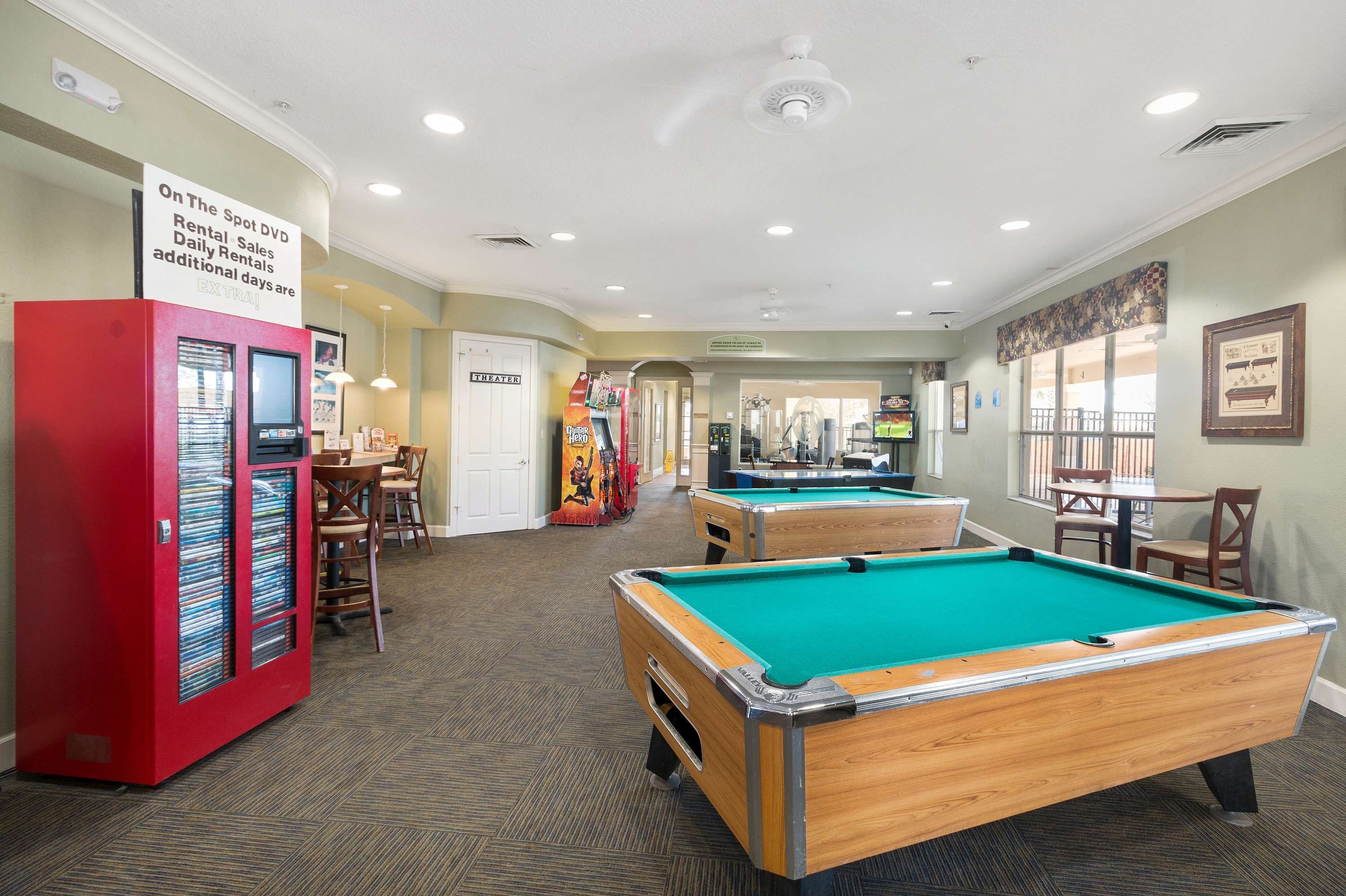 A pool table area with a red vending machine and a sign indicating rental availability. - Chic 6BR Pool Themed Rooms Near Disney (Kissimmee)