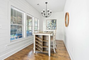 A room with a dining table, chairs, a chandelier, and a window with blinds. - 3 bedroom, 2 bath, with pool house, lake-access, boat slip on Lake Martin (Tallassee)
