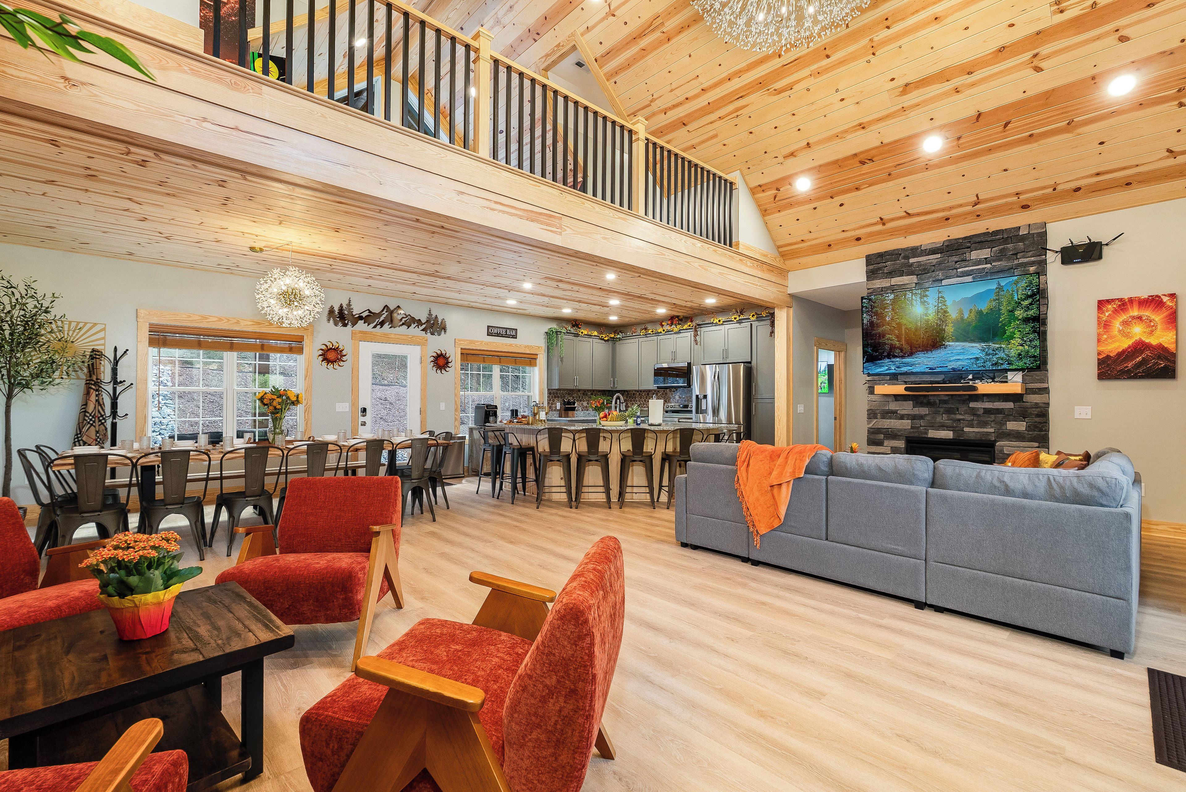 A spacious living area with a high ceiling, a dining area with a view, and a kitchen with modern appliances.