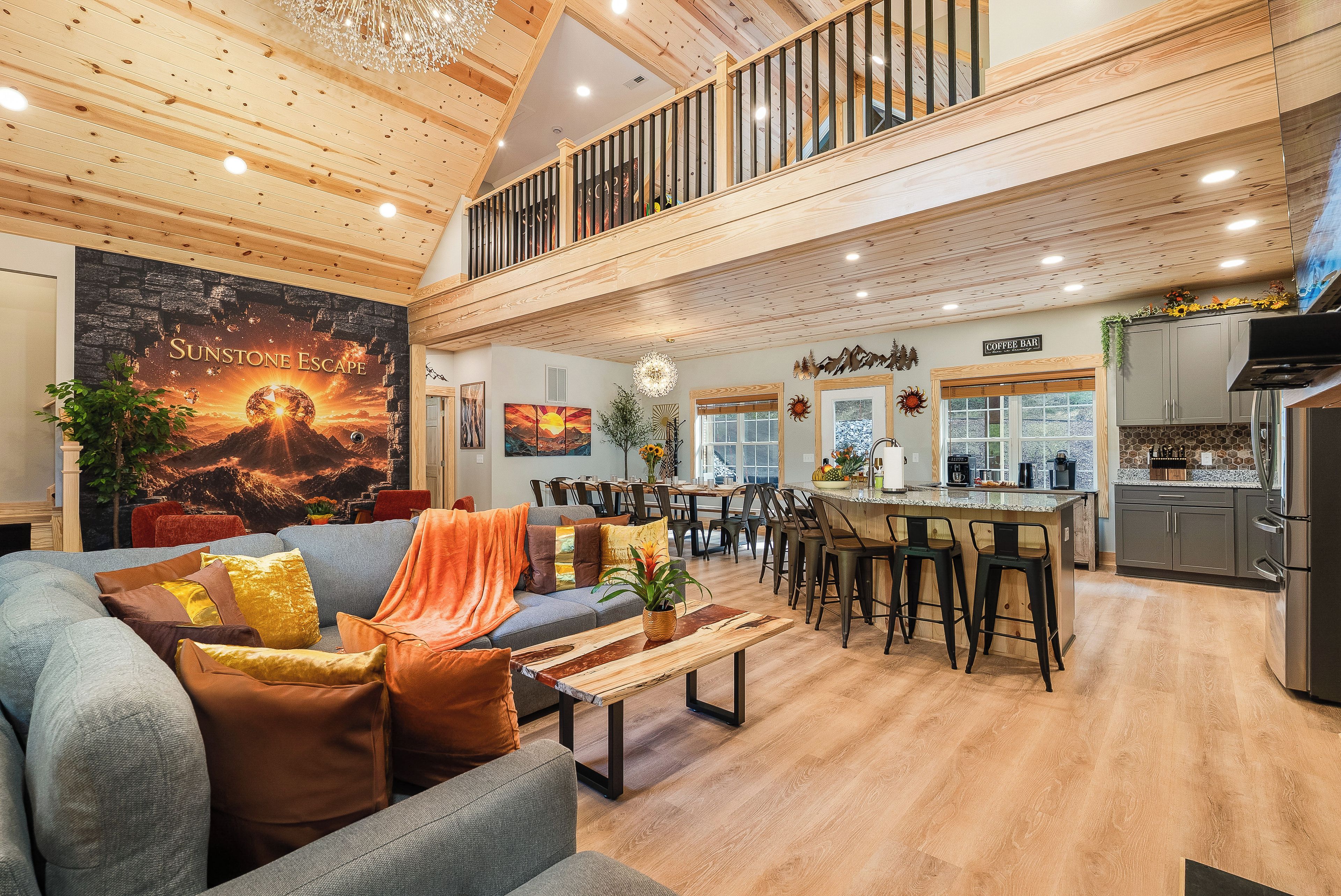 A spacious living area with a high ceiling, a dining area, and a kitchen.