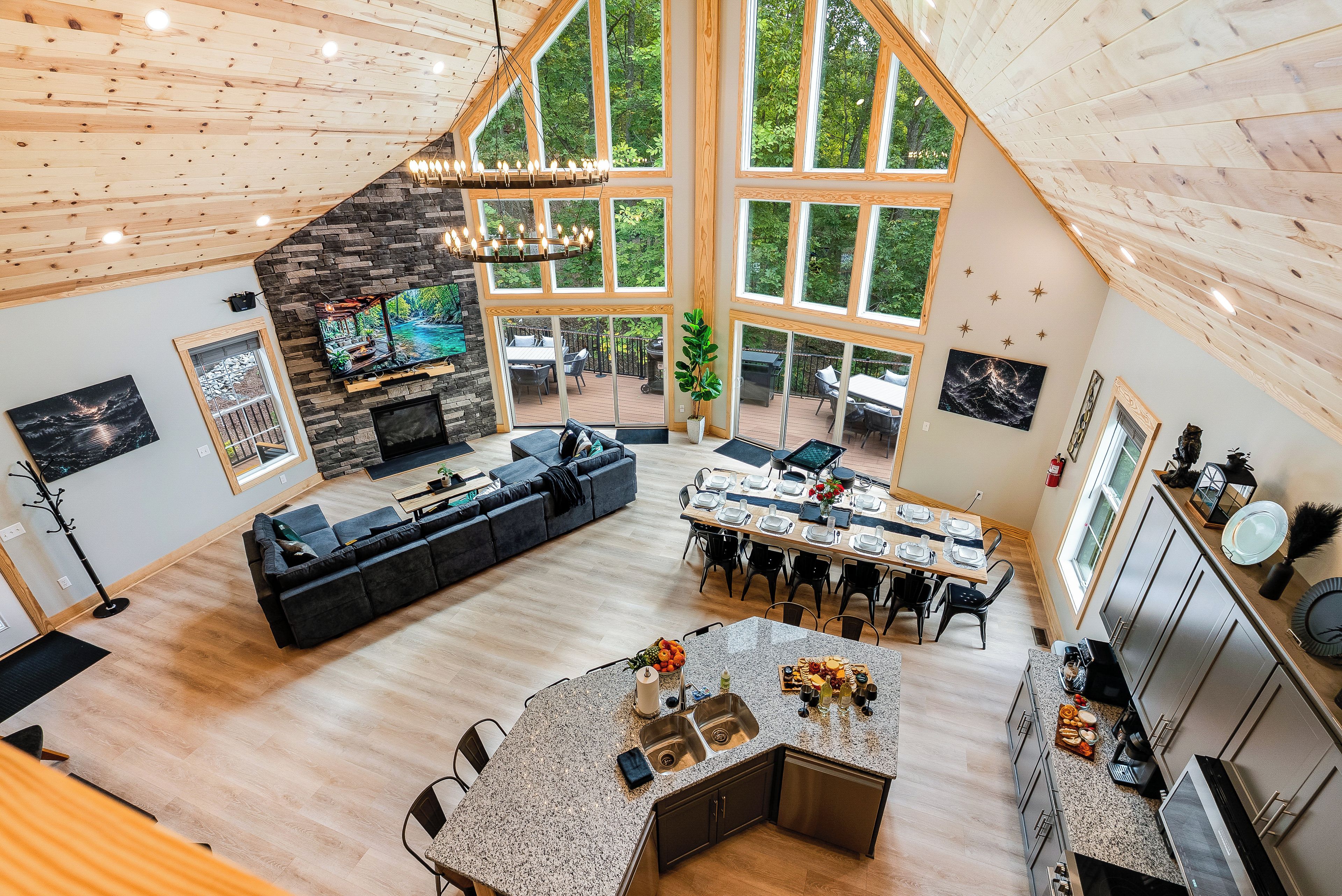 A spacious living area with a large L-shaped sofa, a dining table set for six, and a kitchen with granite countertops.