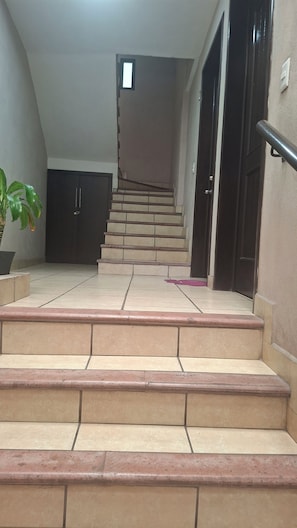 A staircase leading to a door with a handrail on the right. - A1 Cuadra Historic Center New Apartment 2 Bedrooms 24/7 Parking (La Piedad de Cabadas)