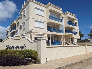 A multi-story building with balconies and a sign reading "Seawinds". - Kite Surfing, Beach opp Fantastic 1-bedroom apartment with AC . (Oistins)