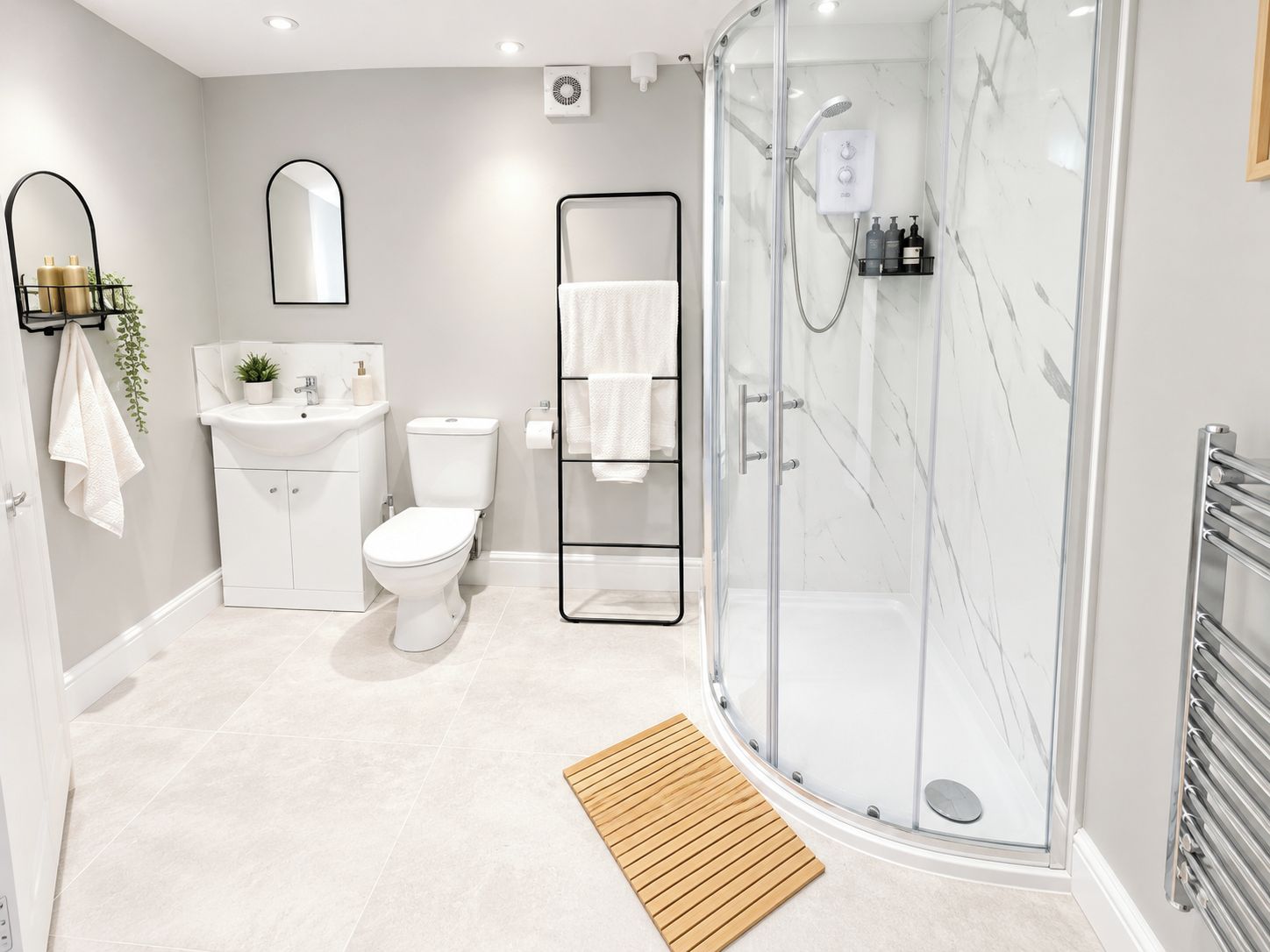 A modern bathroom with a glass-enclosed shower, a white toilet, a sink with a mirror, and a wooden mat.