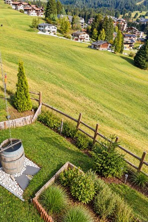 A rural landscape with a wooden fence, a barrel, and a variety of shrubs. - 1511 Foppa 26 by Interhome (Valbella)