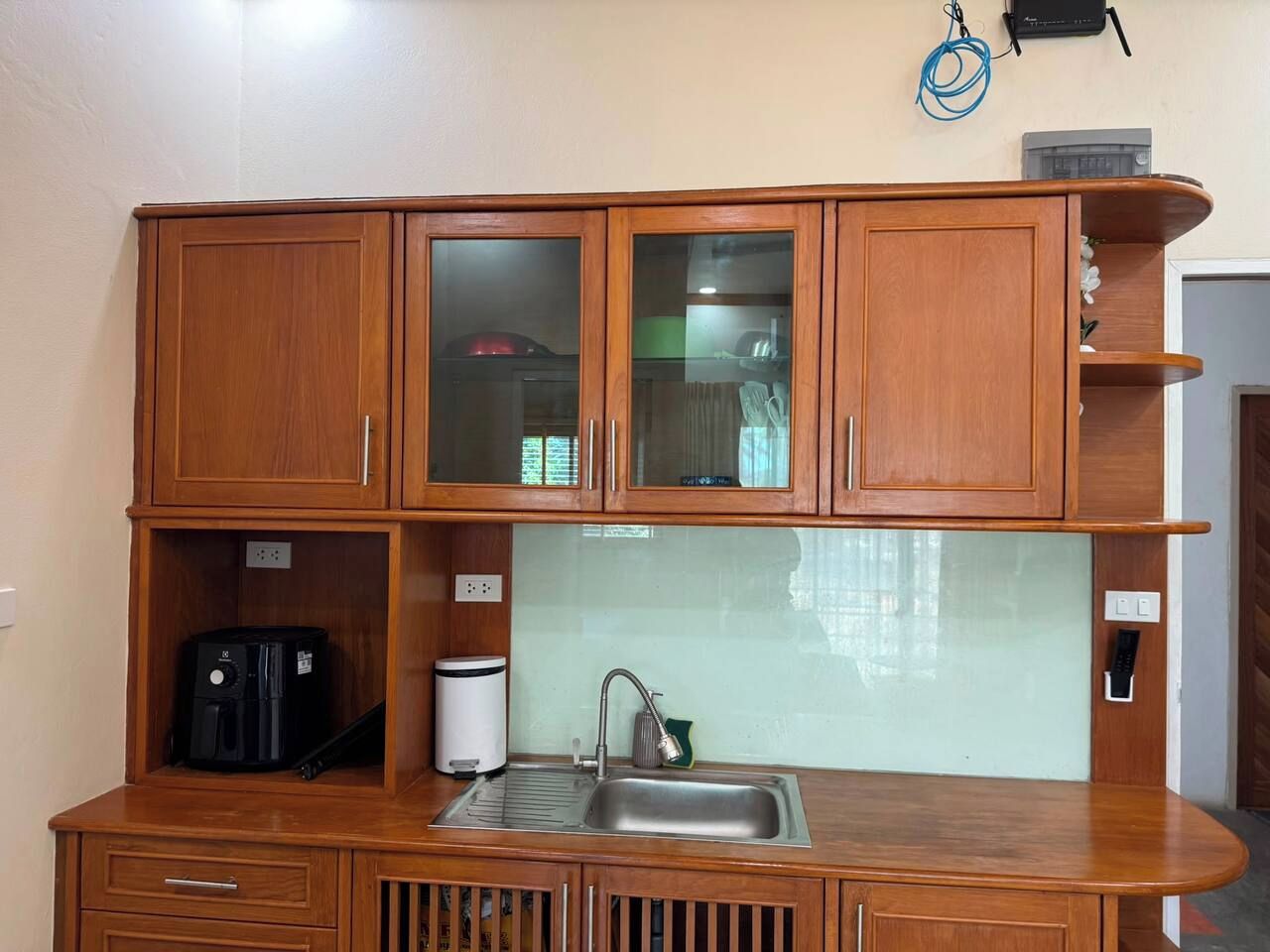 A compact kitchen with a sink, cabinets, and a coffee maker.