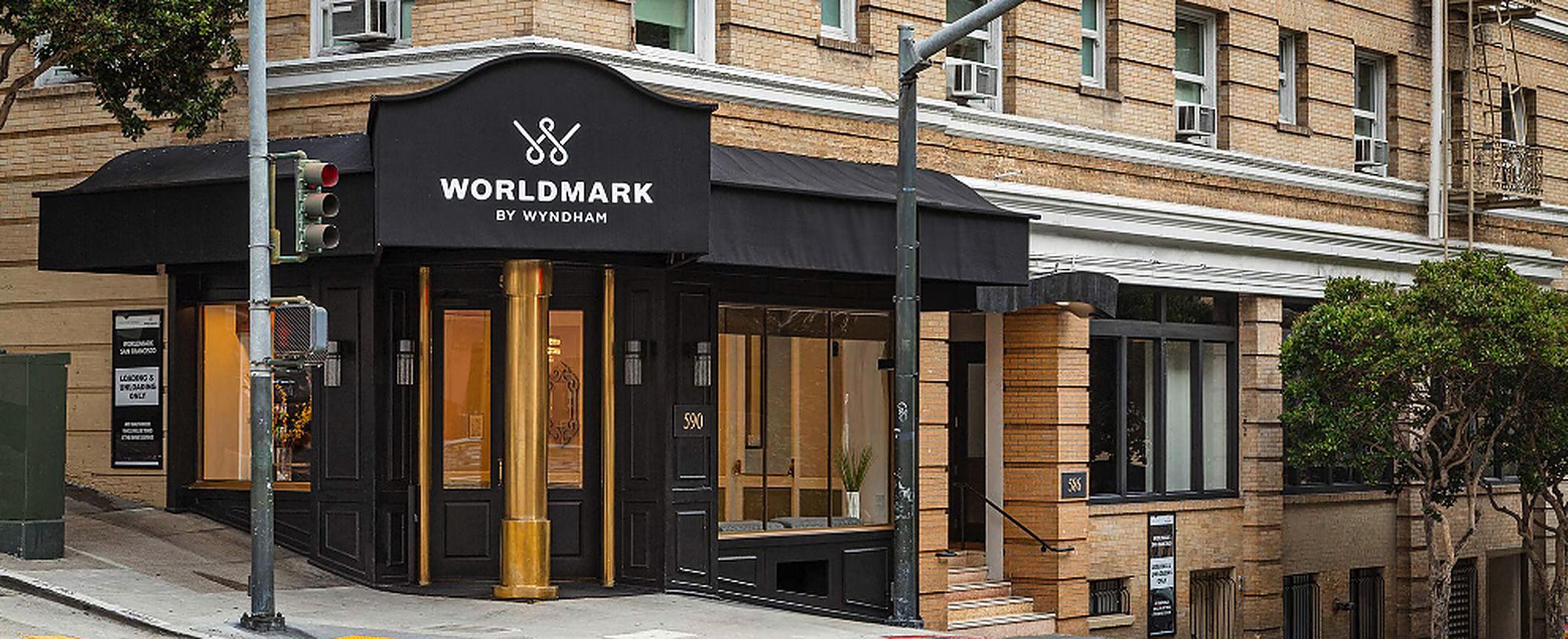 A building with a black awning and a sign that reads 'WORLDMARK BY WYNDHAM'.