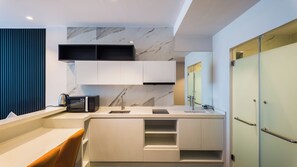 A modern kitchen with a built-in microwave, a sink, and a countertop. - Apartment 1 bedroom in Utopia (Mueang Phuket District)