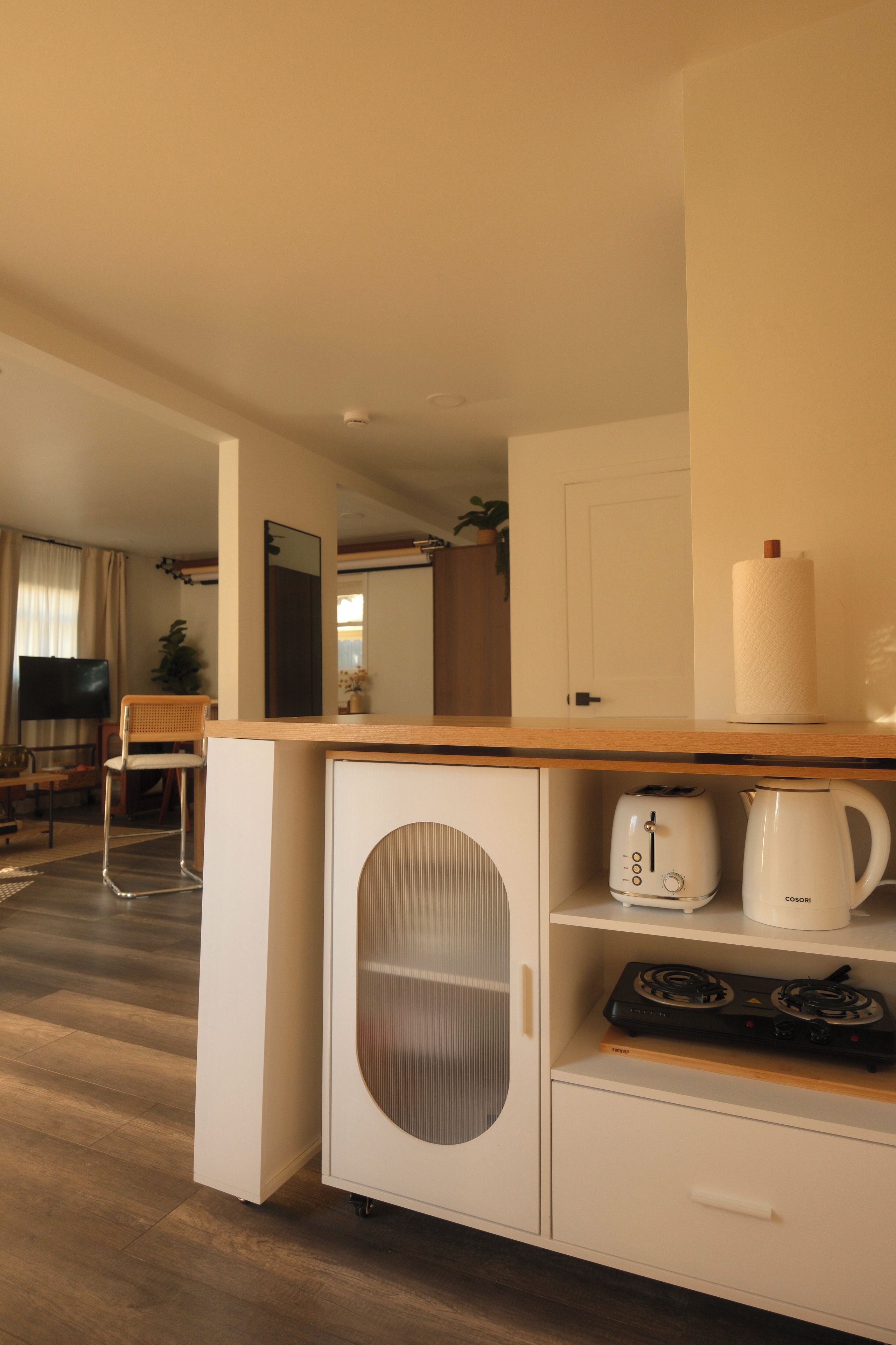 A compact kitchenette with a stove, a coffee maker, and a toaster.